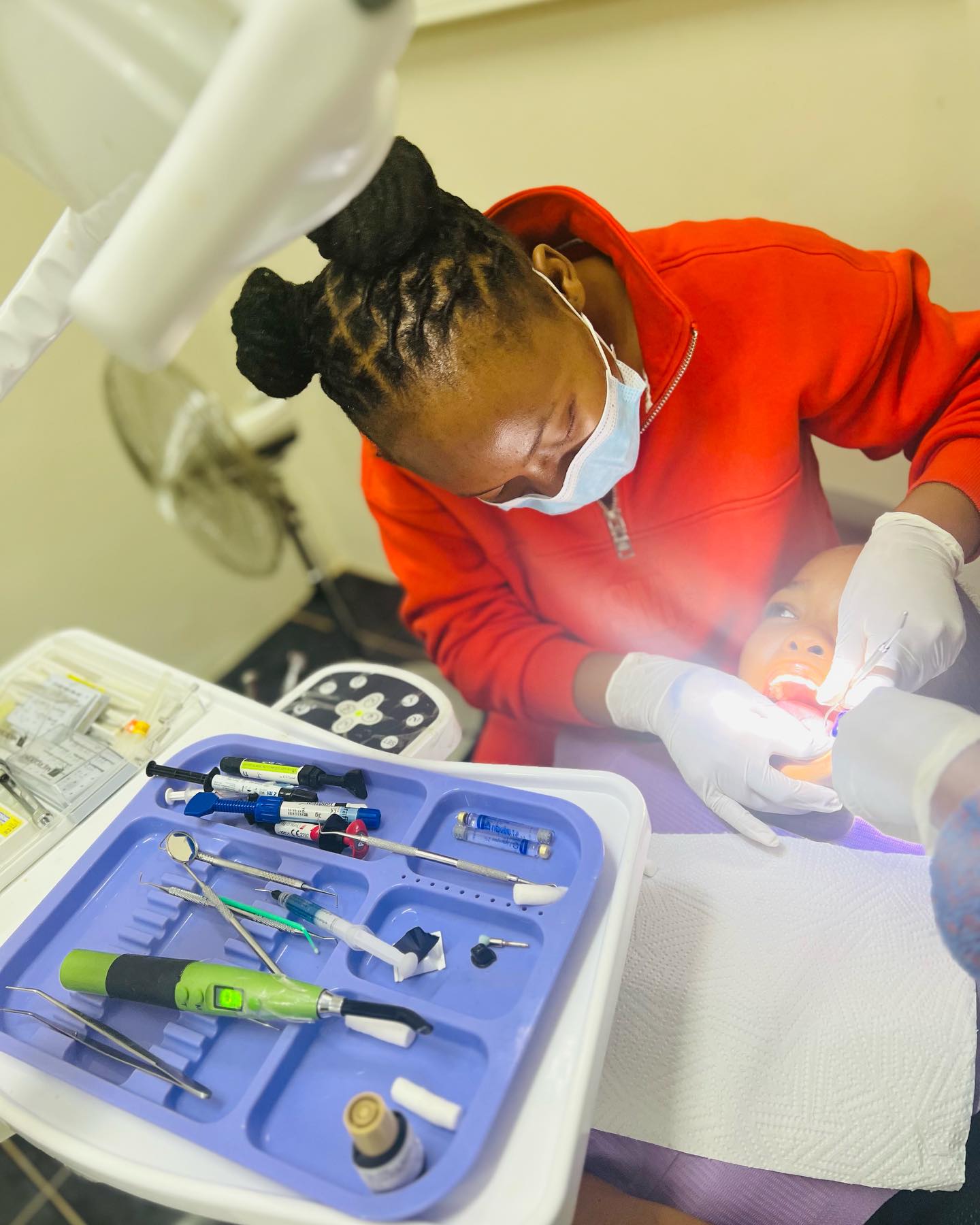 A dental therapist gently caring for a young patient at New Dawn Dental Studio